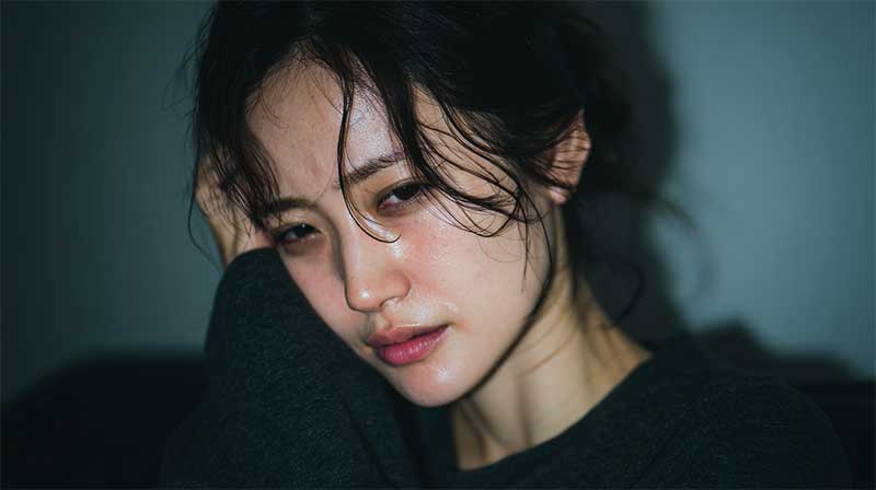 ホメオパシーとインナーチャイルド不安 不安げな女性が頭に手をあててこちらをみている