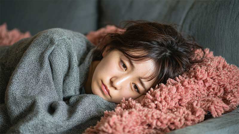 ホメオパシーとインナーチャイルドと寂しがり屋。優柔不断 寂しそうにブランケットに横たわる女性